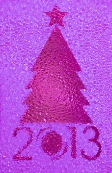 Closeup shot of Christmas tree crystal magenta background