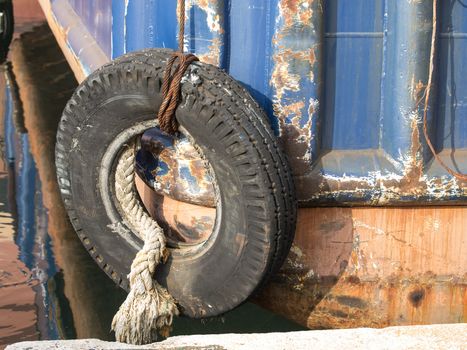 old tyre as a bumper on the boat