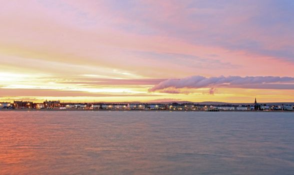 The sunsets over Weymouth seafront taken from view over the sea