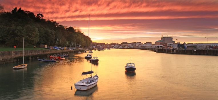 Entrance to weymouth harbour at dusk in southern england