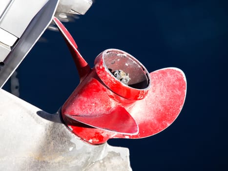 red boat propeller on outboard engine
