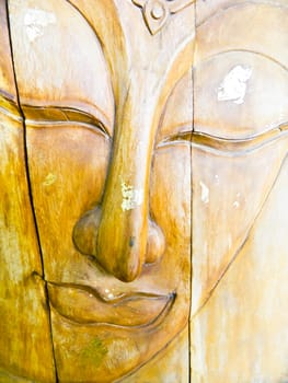 Face of a buddha wood handmade.Sculptures in the temple.