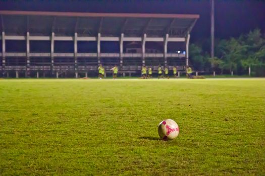 Soccer Football on line of Soccer field with player playing soccer.