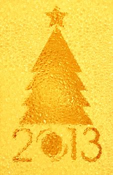 Closeup shot of Christmas tree crystal golden background