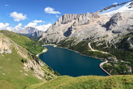summer view of mount Marmolada and Fedaia lake, Trentino, Italy