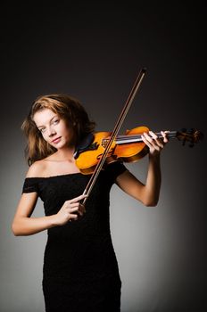 Woman performer with violin in studio