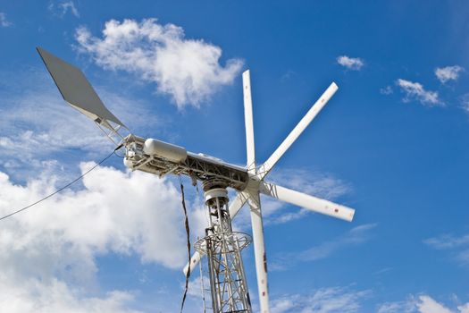 windmills against a blue sky, alternative energy source