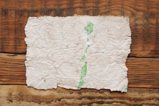 Old white paper sheet on wooden table 