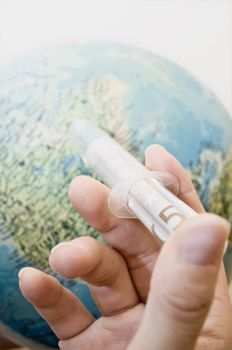 Woman holding a Cash Injection to the Globe