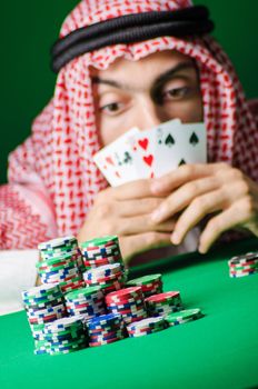 Arab playing in casino - gambling concept with man