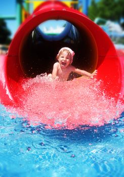Screaming girl riding down the water slide