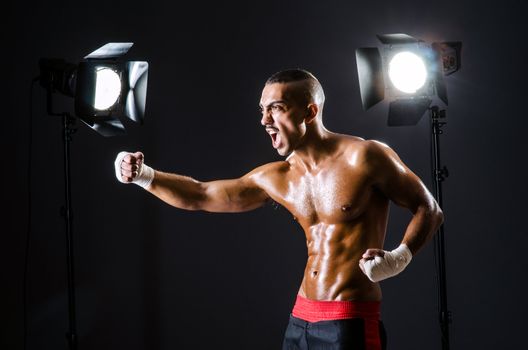 Boxer with studio lights in sports concept