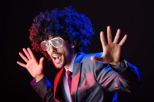 Singer with afro cut in dark studio