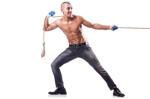 Muscular man pulling the rope