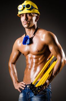 Construction worker in dark studio