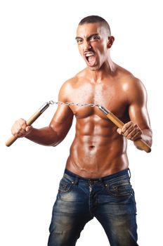 Man in martial arts concept with nunchucks