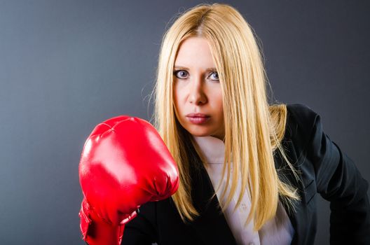 Woman boxer in dark room