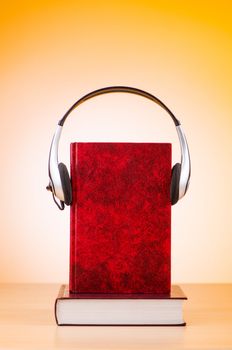 Concept of audio books with earphones on white