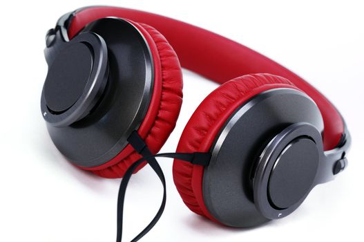 Fashion headphones made of red leather on a white background.