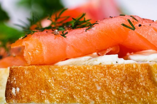 Sandwiches with smoked salmon, cream cheese and herbs.