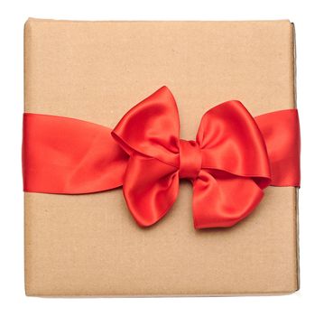 red ribbon bow over recycled nature paper cardboard. holidays background 