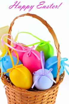 Easter colored eggs in the basket on the white background. Happy Easter! 