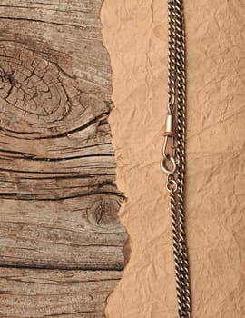 paper vintage and metal chain on wood background