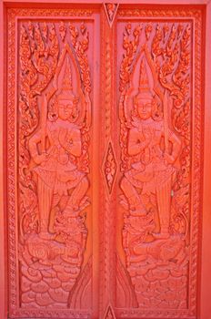 A Buddha pattern on a door of a temple.