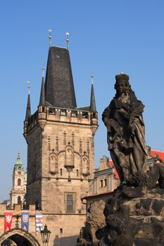 View of ancient sculpture on background with gothic towers in Prague