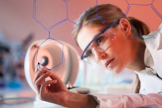 Portrait of a confident female health care professional in his working environment writing structural chemical formula on a glass board.