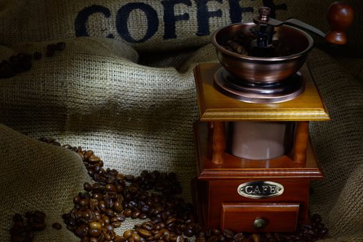 Coffee Mill with beans and burlap. still life