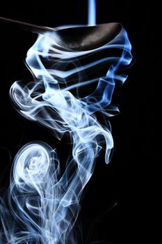 Coloured smoke on natural black background