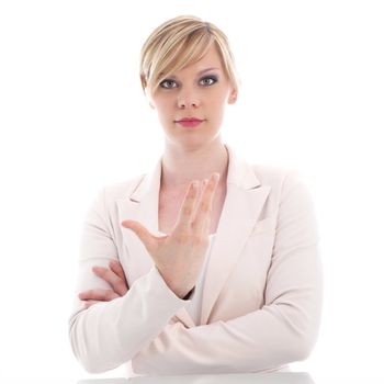 Attractive young professional woman with a serious earnest expression gesticulating with her hand isolated on white