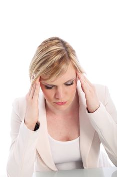 Woman suffering from a migraine or headache massaging her throbbing temples in an effort to relieve the pain isolated on white