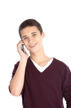Studio portrait over white of a happy teenage boy chatting on his mobile phone