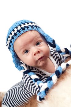 Newborn baby in blue hat and striped clothes