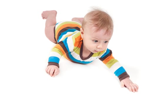 Little baby in multicolored striped clothes lying on white background