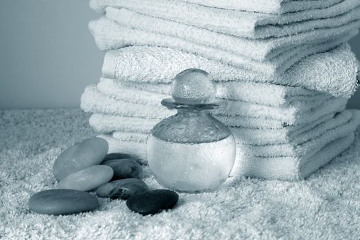 Bottle with massage oil on a background of towel