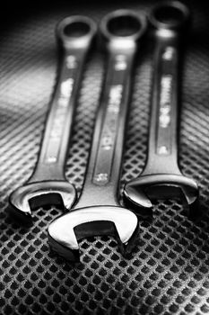 Closeup of iron spanners set over metal surface