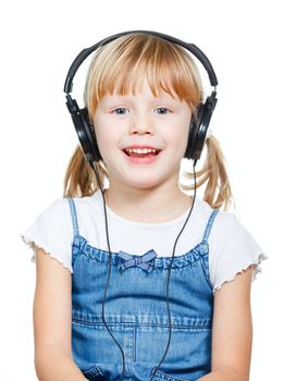 Portrait of cute 4 years girl wearing headphones over a white background