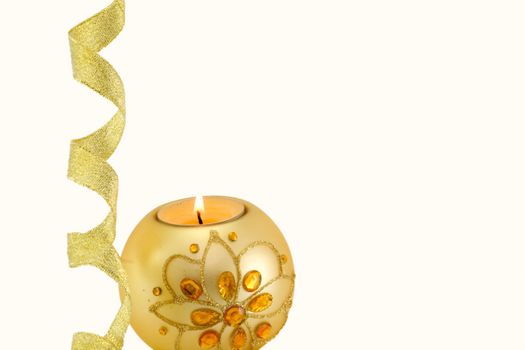 Candle with Christmas decorations and a golden ribbon at the bottom, on white background
