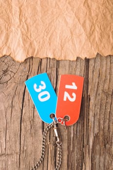 two colorful tags with numbers on old paper 