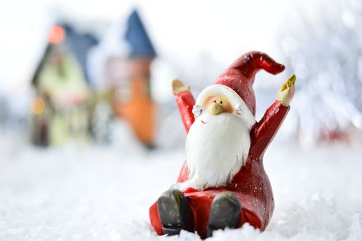 decorative Santa Clause in front of a house on white background