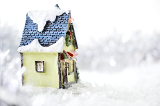 decorative house in artificial snow on white background