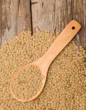 Green lentil on a wooden spoon