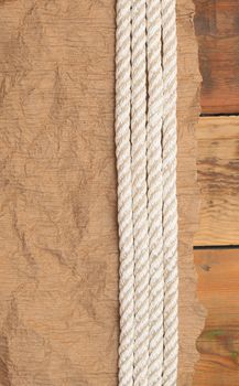 Vintage paper and rope on old wooden boards 