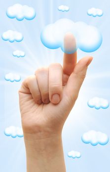 Woman hand touch the cloud against blue sky with clouds. finger touching the cloud 