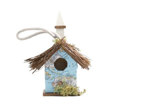 Very small birdhouse with a map as wallpaper.