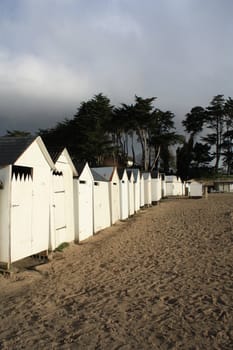 white beach cabins in Brittany, France