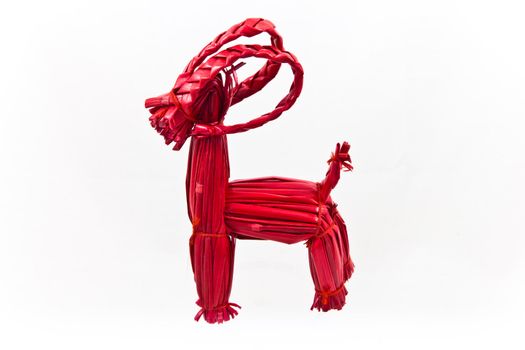 Red Swedish straw Yule Goat on a white background